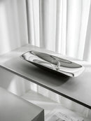 Silver tray on a white surface with a blurred background, Obroi