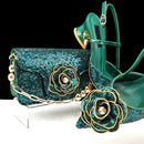 Green high-heeled shoes and matching clutch with floral embellishments on a white background, Obroi