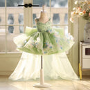 Green floral dress on a mannequin in a room with large windows, Obroi
