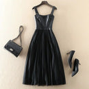 Black leather dress with matching handbag and high heels on a beige background, Obroi