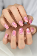 Close-up of hands with pink gradient nail polish on a neutral background, Obroi