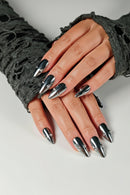 Close-up of hands with black and silver stiletto nails on a light background, Obroi