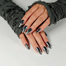 Close-up of hands with black and silver stiletto nails on a neutral background, Obroi