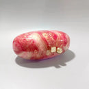 Marbled pink and white case with gold accent on a light gray background, Obroi