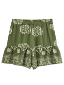 Green shorts with white floral patterns on a white background, Obroi