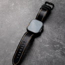 Obroi Smartwatch with a black leather strap on a gray surface