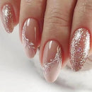 Nails with a combination of glitter and floral design on a light background, Obroi