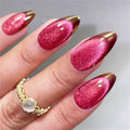 Hand with pink glittery nails and gold accents on a neutral background, Obroi