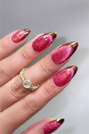 Hand with pink glittery nails and gold accents on a neutral background, Obroi