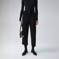 Person wearing a black outfit with a handbag on a white background, Obroi