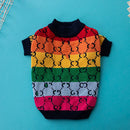 Colorful dog sweater with rainbow pattern on a blue background, Obroi