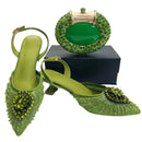 Green high-heeled shoes and matching clutch on a white background, Obroi