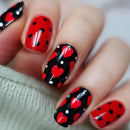 Nails with red and black heart pattern on a white background, Obroi