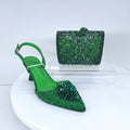 Green studded high-heeled shoes and matching handbag on a white platform, Obroi