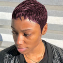 Woman with short, styled hair wearing a black jacket against a striped background, Obroi