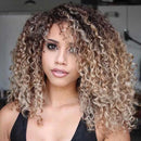 Woman with curly hair in a blurred indoor setting, Obroi