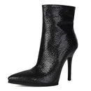 A black snakeskin-patterned ankle boot with a pointed toe and a high stiletto heel, shown on a plain white background with a brand label in the top-left corner, Obroi