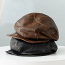 Brown leather cap on a white surface with a light gray background, Obroi
