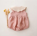 Pink baby romper with a white collar on a light background, Obroi