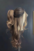 Mannequin head with long, wavy hair styled in a ponytail against a dark wall, Obroi