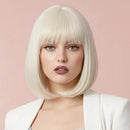 Woman with a blonde bob wig against a pink background Obroi