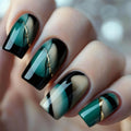 Nails with green, black, and gold design on a blurred background, Obroi