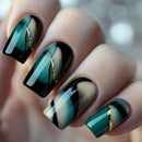 Nails with green, black, and gold design on a blurred background, Obroi