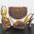 Pair of ornate high-heeled shoes with a matching handbag on a dark surface, Obroi