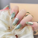 Close-up of a hand with decorative nails holding a white flower, Obroi