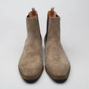 Pair of brown suede ankle boots on a light gray background with 'Obroi' branding.