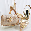Gold embellished handbag and high-heeled shoes on a white background, Obroi