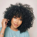 Woman with voluminous curly hair styled by Obroi, wearing a light blue top, Obroi
