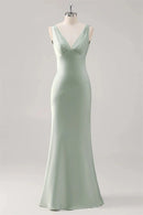 Mint green evening gown on a mannequin against a light gray background