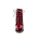 Red patent leather boot with pink laces on a white background, Obroi