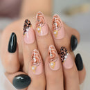 Manicured nails with leopard print, floral, and pearl designs on a neutral background ,Obroi
