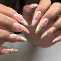 Nails with floral design held by a person, Obroi