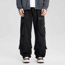 Person wearing black cargo pants on a light gray background, Obroi