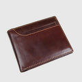 Brown leather wallet on a light gray background with 'Obroi' branding.