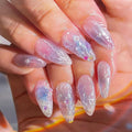 Hand with long, decorative nails featuring a butterfly design, Obroi