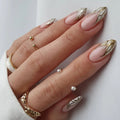 Hand with pink and gold nail art on a white background, Obroi
