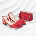 A matching red glittery women's accessory set featuring pointed slingback heels with 3D fabric rose embellishments on the toes, alongside a matching red glitter clutch handbag with a gold-tone chain strap and clasp, Obroi