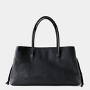Black handbag on a light gray background with 'Obroi' branding.