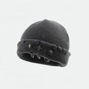 Gray knit beanie with decorative elements on a light gray background obroi