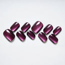 Purple glittery nail polish swatches on a white background, Obroi