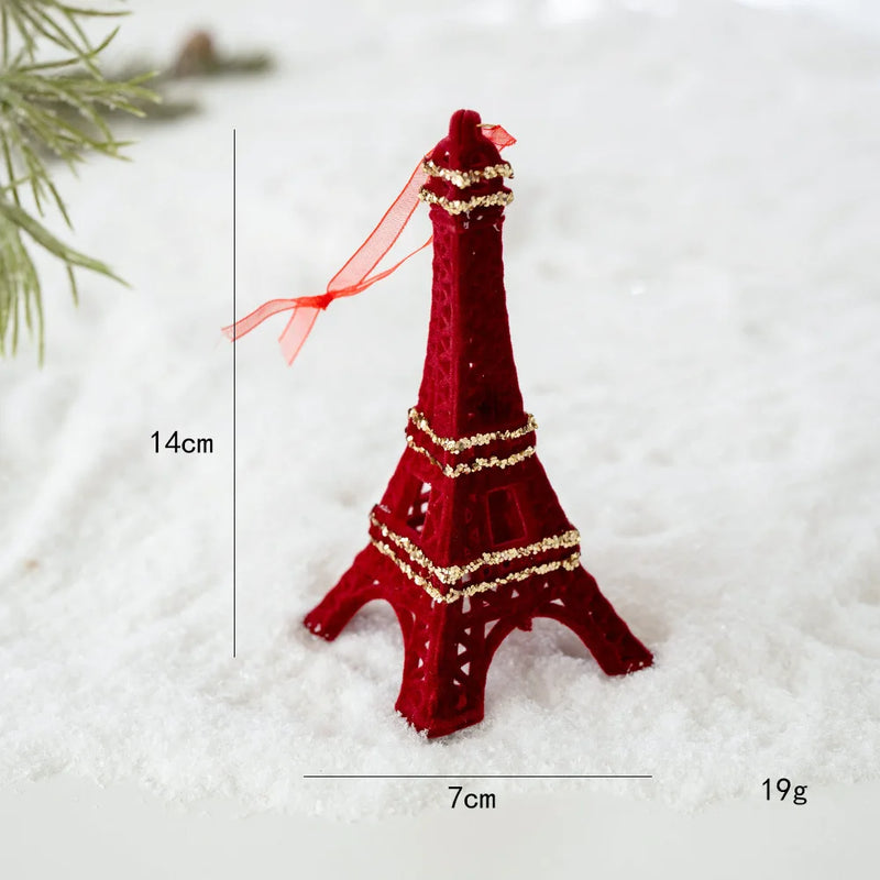 Red Eiffel Tower ornament with gold accents on a snowy background, Obroi