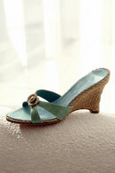 Teal wedge sandal with woven strap on a textured surface, Obroi
