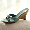 Teal wedge sandal with woven strap on a textured surface, Obroi