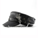 Black leather cap with skeleton hand charm on a white background, Obroi