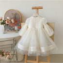 White dress on a mannequin with a floral painting in the background, Obroi