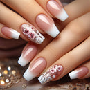 Close-up of hands with pink and white floral nail art on a decorative background, Obroi